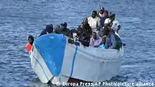 Migrants arrive on a small boat at La Restinga port on the canary island of El Hierro on Sunday Feb. 4, 2024. Spain's marine rescue service says nearly 1,000 migrants from sub-Saharan countries arrived in Spain's Canary Islands in 18 boats in the past three days. The agency says one body was found aboard one of the boats intercepted Monday. (Europa Press via AP) **SPAIN OUT**