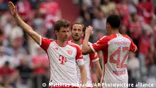 Bayern's Thomas Mueller, left, celebrates after scoring his side's second goal during the German Bundesliga soccer match between Bayern Munich and Cologne at the Allianz Arena in Munich, Germany, Saturday, April 13, 2024. (AP Photo/Matthias Schrader)