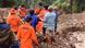 Rescuers carrying a body bag at a landslide site in Tana Toraja Rescuers carrying a body bag at a landslide site in Tana Toraja