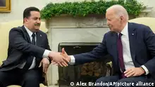 President Joe Biden, right, and Iraq's Prime Minister Shia al-Sudani shake hands during a meeting in the Oval Office of the White House, Monday, April 15, 2024, in Washington. (AP Photo/Alex Brandon)