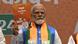 Indian Prime Minister Narendra Modi holding his party's manifesto Indian Prime Minister Narendra Modi holding his party's manifesto