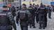 Police in riot gear gather outside a former bus company headquarters south of Paris where some 450 migrants had been squatting Police in riot gear gather outside a former bus company headquarters south of Paris where some 450 migrants had been squatting