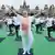 Indian PM Narendra Modi doing yoga together with a group of people at an event in Mysore city, India