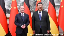 In this photo released by Xinhua News Agency, Chinese President Xi Jinping, right and German Chancellor Olaf Scholz pose for a photo at the Diaoyutai State Guesthouse in Beijing, China, on Tuesday, April 16, 2024. (Xie Huanchi/Xinhua via AP)