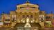 Berlin Konzerthaus: exterior of a classical building with columns and statues lit up at night. Berlin Konzerthaus: exterior of a classical building with columns and statues lit up at night.