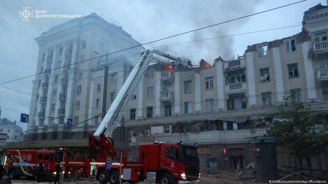 Fire truck in front of badly damaged large building
