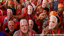 FILE PHOTO: Supporters of India's Prime Minister Narendra Modi wear masks of his face, as they attend an election campaign rally in Meerut, India, March 31, 2024. REUTERS/Anushree Fadnavis/File Photo