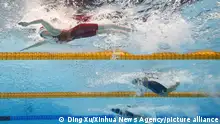 (220106) -- BEIJING, Jan. 6, 2022 (Xinhua) -- This photo taken by an underwater camera shows Zhang Yufei (L) of China competing during the women's 200m butterfly final at the Tokyo 2020 Olympic Games in Tokyo, Japan, July 29, 2021. Zhang Yufei claimed the title of the event. (Xinhua/Ding Xu)