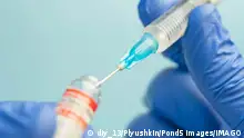 Macro of a hypodermic syringe or needle being filled with mRNA vaccine from bottle against a blue background xkwx closeup, vaccination, liquid, virus, injection, syringe, macro, medicine, needle, medical, vaccine, drug, science, concept, laboratory, transparent, coronavirus, pharmaceutical, blue, dose, immunization, equipment, health, health care, illness, epidemic, covid-19, research, healthcare, chilled, mrna, close up, therapy, nobody, cold, drop, dna, insulin, doctor, messenger rna, covid-19 vaccine, glass, addiction, antidote, technology, background, pharmacy, medication, rna, bottle