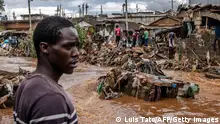 TOPSHOT - A man stands next to an area were houses were destroyed by floods following torrential rains at the Mathare informal settlement in Nairobi, on April 25, 2024. Torrential rains triggered floods and caused chaos across Kenya, blocking roads and bridges and engulfing homes in slum districts. The death toll from flash floods in Kenya's capital Nairobi has risen to 13 on April 25, 2024, police said. Kenyans have been warned to stay on alert, with the forecast for more heavy rains across the country in the coming days. (Photo by LUIS TATO / AFP) (Photo by LUIS TATO/AFP via Getty Images)