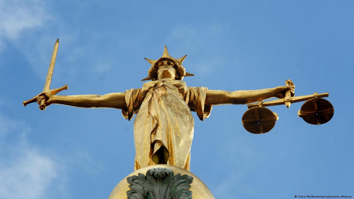 Archive photo of a statue Lady Justice, holding scales and a sword, on top of the Central Criminal Court.