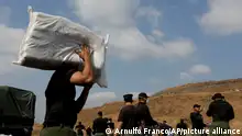 01/04/2016 A narcotics agent carries a sack containing seized drugs, as agents prepare to destroy the drugs, on the outskirts of Panama City, Friday, April 1, 2016. Panamanian National Police set fire to 8.9 tons of cocaine, marijuana, and heroin, seized during drug operations in the last four months. (AP Photo/Arnulfo Franco)