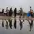 People walk near a puddle at a camp in Rafah