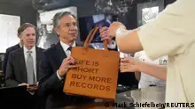 U.S. Secretary of State Antony Blinken takes a bag after buying records during a visit to Li-Pi record store in Beijing, China, April 26, 2024. Mark Schiefelbein/Pool via REUTERS