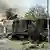 A damaged military truck is pictured following an explosion at an army base in Kampong Speu province 