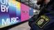 A police officer stands in front of a wall with the Eurovision tagline "United by Music." A police officer stands in front of a wall with the Eurovision tagline "United by Music."