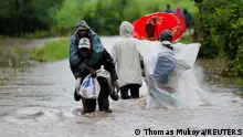 01/05/2024**Residents wade through flood waters after a seasonal river burst its banks following heavy rainfall in Kitengela municipality of Kajiado County, near Nairobi, Kenya May 1, 2024. REUTERS/Thomas Mukoya