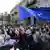 Demonstrators blocked by the police wave a EU flag during an opposition protest against "the Russian law" near the Parliament building in Tbilisi, Georgia, on Wednesday, May 1, 2024