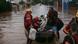 Firefighters rescue a man and his dog from a flooded area at the city center of Sao Sebastiao do Cai, Rio Grande do Sul state, Brazil Firefighters rescue a man and his dog from a flooded area at the city center of Sao Sebastiao do Cai, Rio Grande do Sul state, Brazil
