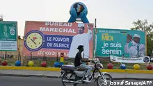 02/05/2024**A motorbike driver passes in front of campaign posters of Chad's presidential candidates in N'Djamena on May 2, 2024. Chad's presidential election comes just over three years after a military junta proclaimed General Mahamat Idriss Deby Itno, son of Marshal Idriss Deby Itno, who had been killed on his way to the front against rebels after ruling Chad with an iron fist for 30 years, to be the transitional president on April 20, 2021. Mahamat Deby is running for president and is almost certain to win after having eliminated his main rivals by violently muzzling and repressing all opposition. (Photo by Issouf SANOGO / AFP)