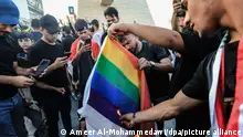 Supporters of the Popular Mobilization Forces burn a rainbow flag during a protest in Tahrir Square in Baghdad to denounce the burning of Islam's holy book the Quran and the Iraqi flag in the Swedish capital Stockholm.