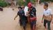 Rescuers carry a victim of a flood in Wajo, South Sulawesi, Indonesia Rescuers carry a victim of a flood in Wajo, South Sulawesi, Indonesia