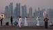 Doha's skyline glitters in the evening light as people gather on the Corniche promenade Doha's skyline glitters in the evening light as people gather on the Corniche promenade