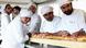French bakers stand near a large rotating oven in an attempt to beat the world record for the longest baguette French bakers stand near a large rotating oven in an attempt to beat the world record for the longest baguette