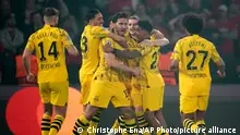 Dortmund's Mats Hummels, center, celebrates with teammates after scoring his sides first goal during the Champions League semifinal second leg soccer match between Paris Saint-Germain and Borussia Dortmund at the Parc des Princes stadium in Paris, France, Tuesday, May 7, 2024. (AP Photo/Christophe Ena)