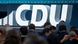 The CDU logo at a party conference The CDU logo at a party conference