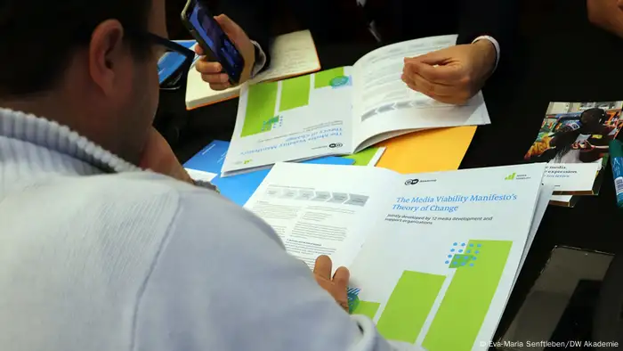 A participant at the 2024 World Press Freedom Day conference in Santiago de Chile browses through the Media Viability Manifesto