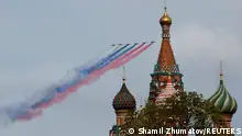 Russian Su-25 jet aircraft release smoke in the colours of the Russian state flag over St. Basil's Cathedral during a flypast and a military parade on Victory Day, which marks the 79th anniversary of the victory over Nazi Germany in World War Two, in Moscow, Russia, May 9, 2024. REUTERS/Shamil Zhumatov