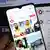A person holds up a phone that displays an overview of reels posted to TikTok belonging to the account muslim.interaktiv