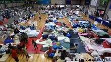 People who have been evacuated from flooded areas rest at a gym used as a shelter in Porto Alegre, Rio Grande do Sul state, Brazil May 10, 2024. REUTERS/Diego Vara