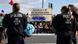 Police officers stand guard in front of activists at Tesla factory in Grünheide, Germany Police officers stand guard in front of activists at Tesla factory in Grünheide, Germany