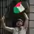 Pro-Palestinian activists from Ireland beat a drum with Palestinian flag on it