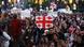 Protesters holding Georgian flags in Tbilisi on May 13, 2024 Protesters holding Georgian flags in Tbilisi on May 13, 2024