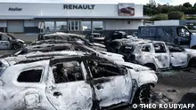 14.05.2024 TOPSHOT - Burnt cars are pictured at a car dealer store in the Magenta district in Noumea on May 14, 2024, amid protests linked to a debate on a constitutional bill aimed at enlarging the electorate for upcoming elections of the overseas French territory of New Caledonia. After scenes of violence of great intensity including burned vehicles, looted stores and clashes between demonstrators and the police, a curfew was decreed in Noumea, 17,000 kilometers from Paris, as the independentists of the overseas French territory of New Caledonia oppose a constitutional revision they fear will further minimize the indigenous Kanak people. (Photo by Theo Rouby / AFP)