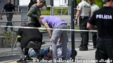 Police arrest a man after Slovak Prime Minister Robert Fico was shot and injured following the cabinet's away-from-home session in the town of Handlova, Slovakia, Wednesday, May 15, 2024. Fico is in life-threatening condition after being wounded in a shooting Wednesday afternoon, according to his Facebook profile. (Radovan Stoklasa/TASR via AP)