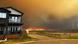 A fire approaching a home in Fort McMurray, Alberta, Canada A fire approaching a home in Fort McMurray, Alberta, Canada