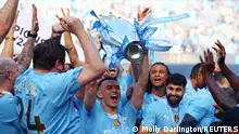 Soccer Football - Premier League - Manchester City v West Ham United - Etihad Stadium, Manchester, Britain - May 19, 2024 Manchester City's Phil Foden and teammates celebrate with the trophy after winning the Premier League REUTERS/Molly Darlington EDITORIAL USE ONLY. NO USE WITH UNAUTHORIZED AUDIO, VIDEO, DATA, FIXTURE LISTS, CLUB/LEAGUE LOGOS OR 'LIVE' SERVICES. ONLINE IN-MATCH USE LIMITED TO 120 IMAGES, NO VIDEO EMULATION. NO USE IN BETTING, GAMES OR SINGLE CLUB/LEAGUE/PLAYER PUBLICATIONS. PLEASE CONTACT YOUR ACCOUNT REPRESENTATIVE FOR FURTHER DETAILS..