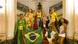 A group of models wearing Brazilian-flag themed outfits stand on an elegant red-carpeted stairway in a marble hall A group of models wearing Brazilian-flag themed outfits stand on an elegant red-carpeted stairway in a marble hall