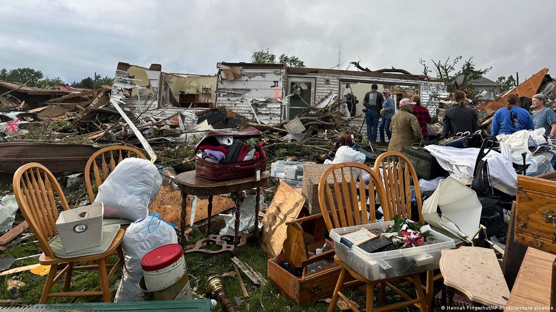 People examine damage after a tornado moved through Greenfield, Iowa,