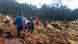 People cross over the landslide area to get to the other side in Yambali village, Papua New Guinea on Friday, May 24 People cross over the landslide area to get to the other side in Yambali village, Papua New Guinea on Friday, May 24