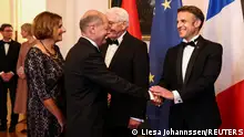 German Chancellor Olaf Scholz shakes hand with French President Emmanuel Macron as they attend a state dinner at Bellevue castle in Berlin, Germany May 26, 2024. REUTERS/Liesa Johannssen
