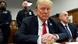 A seated man with an orange complexion and wearing a dark suit and red tie (former US President Donald Trump), looks into the camera in a New York courtroom A seated man with an orange complexion and wearing a dark suit and red tie (former US President Donald Trump), looks into the camera in a New York courtroom