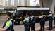 Police officers stand guard as a Correctional Services Department vehicle leaves the West Kowloon Magistrates' Courts in Hong Police officers stand guard as a Correctional Services Department vehicle leaves the West Kowloon Magistrates' Courts in Hong