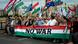People on a bridge hold up a huge banner in the colors of the Hungarian flag emblazoned with the words 'no war.' Behind them, other demonstrators hold a variety of flags and placards, Budapest, Hungary, June 1, 2024 People on a bridge hold up a huge banner in the colors of the Hungarian flag emblazoned with the words 'no war.' Behind them, other demonstrators hold a variety of flags and placards, Budapest, Hungary, June 1, 2024