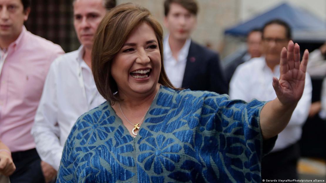A woman (Mexican presidential candidate Xochitl Galvez) smiles as she waves to onlookers 