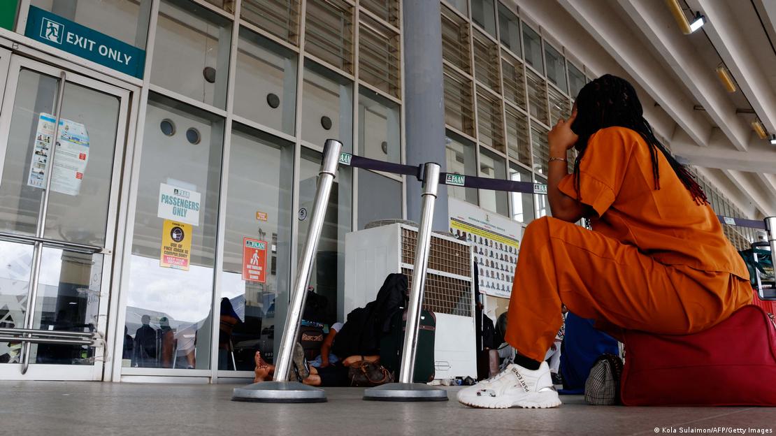  A passenger reacts while stranded at the airport gate in Nigeria
